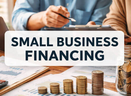 Close-up of two individuals reviewing financial charts and documents at a desk. In the foreground, stacks of coins are arranged, symbolizing small business financing. The title 'SMALL BUSINESS FINANCING' is prominently displayed across the top in bold blue text.